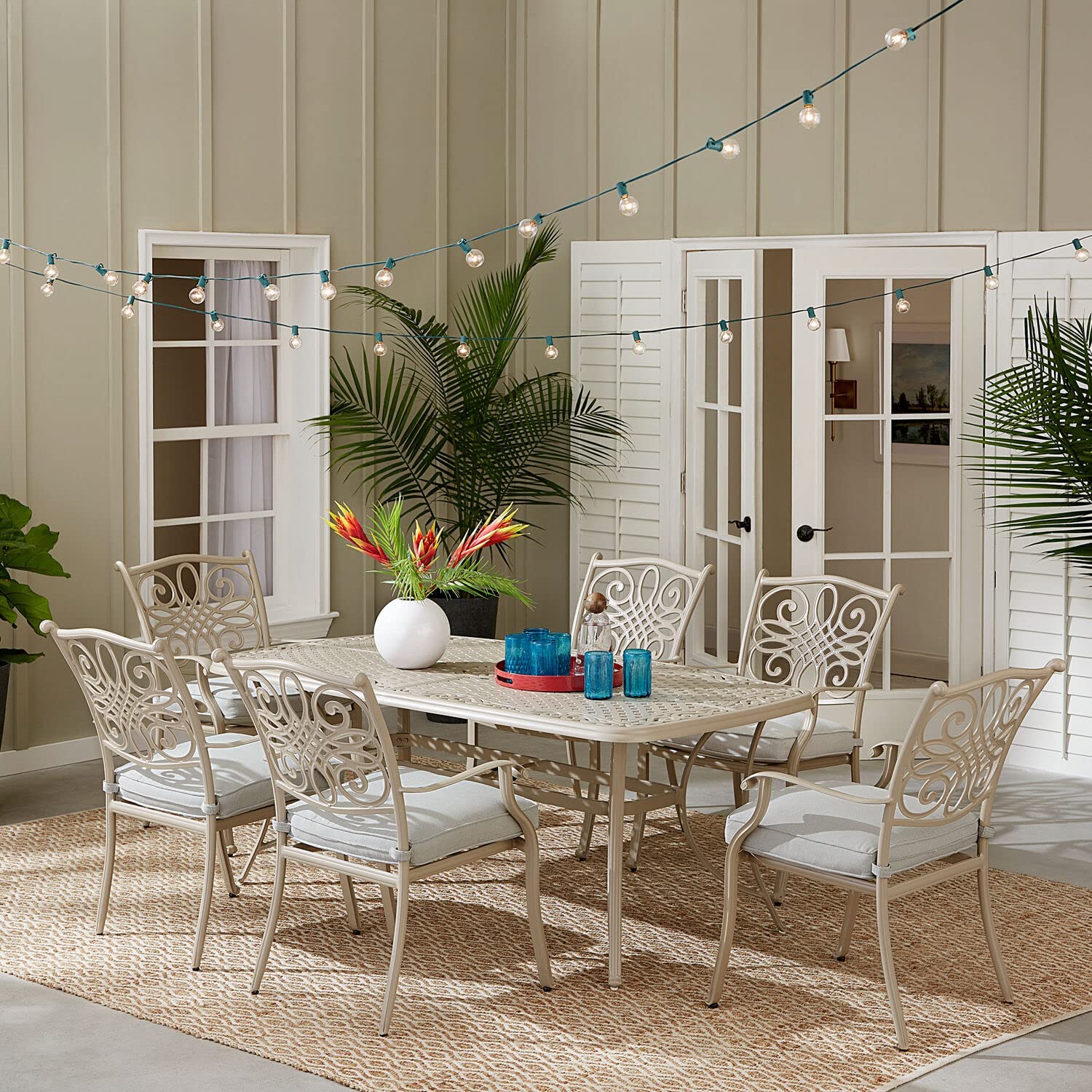 Hanover 7-Piece Tan with a 60 Cast-top Six Traditions Rust-Free Outdoor Patio Set Cushions, 6 Swivel Rockers and Aluminum Round Dining Table